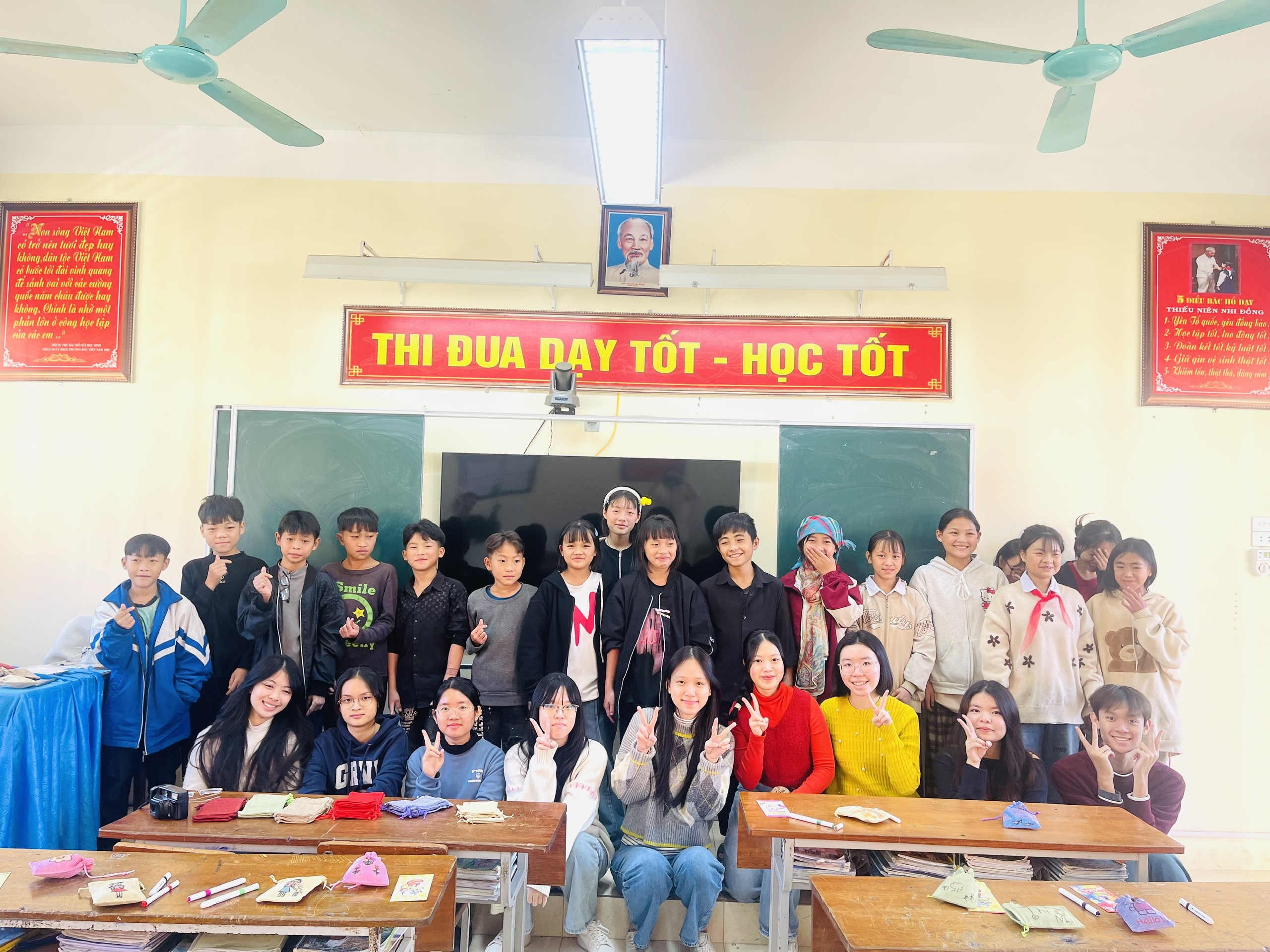 A classroom full of students holding their new notebooks